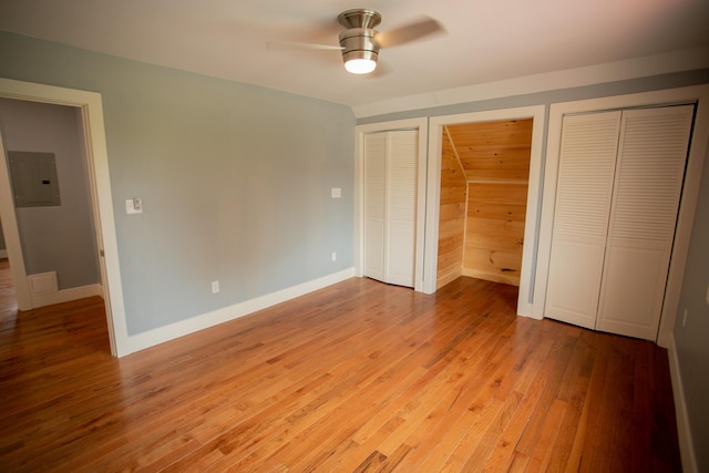 16 Main St, Bradley, ME 04411 - unfurnished bedroom featuring electric panel, multiple closets, light wood-style flooring, and ceiling fan