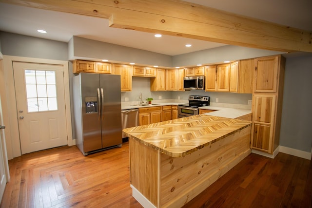 16 Main St, Bradley, ME 04411 - kitchen featuring stainless steel appliances, light brown cabinetry, a peninsula, recessed lighting, and light wood-type flooring