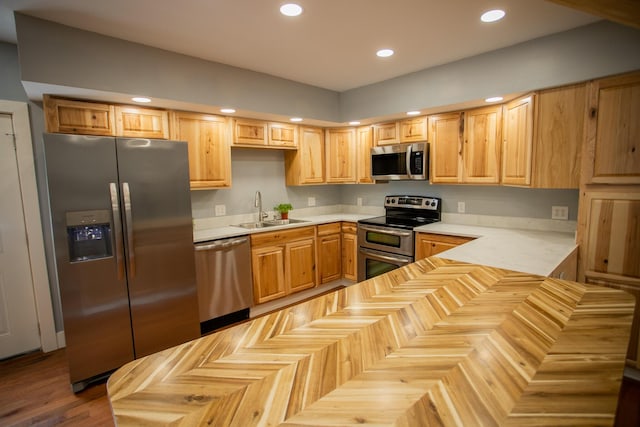 16 Main St, Bradley, ME 04411 - kitchen with stainless steel appliances, light countertops, recessed lighting, light brown cabinetry, and a peninsula