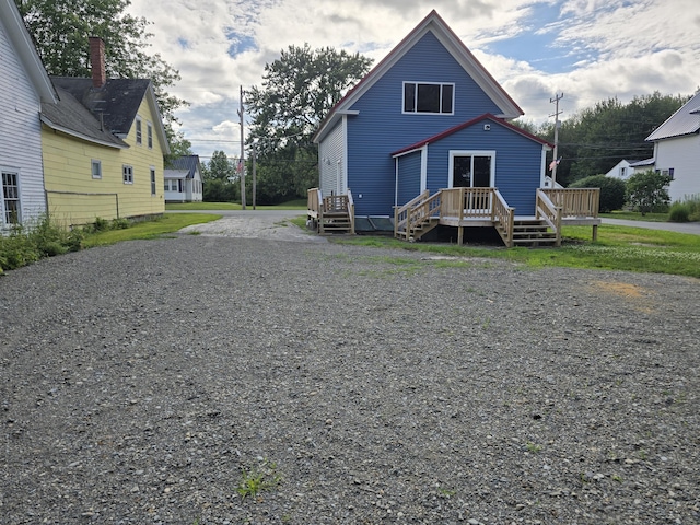 16 Main St, Bradley, ME 04411 - rear view of property with a wooden deck and gravel driveway