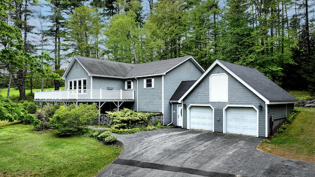 29 Bear Pond Rd, Waterford, ME 04088 - view of front facade with a shingled roof, a front yard, an attached garage, asphalt driveway, and view of wooded area
