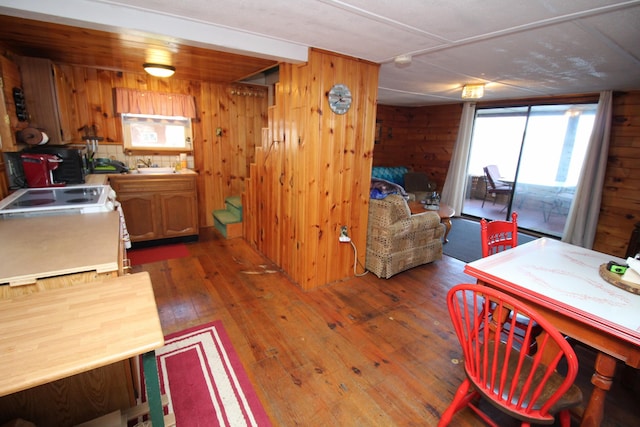 81 Shore Dr, Sabattus, ME 04280 - kitchen featuring hardwood / wood-style floors, wooden walls, and brown cabinetry
