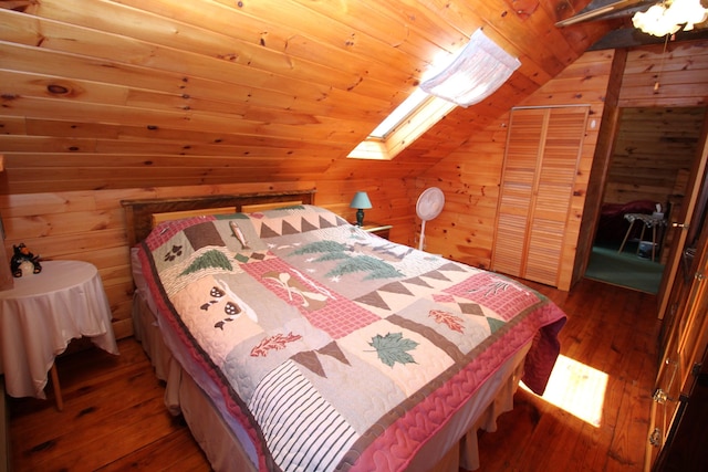 81 Shore Dr, Sabattus, ME 04280 - bedroom with lofted ceiling, hardwood / wood-style floors, wooden walls, a skylight, and wood ceiling