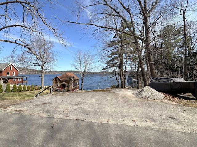 81 Shore Dr, Sabattus, ME 04280 - view of yard with a water view, a storage unit, and asphalt driveway