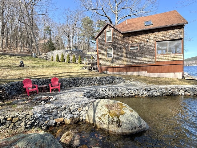 81 Shore Dr, Sabattus, ME 04280 - view of side of home with an outdoor fire pit and a water view