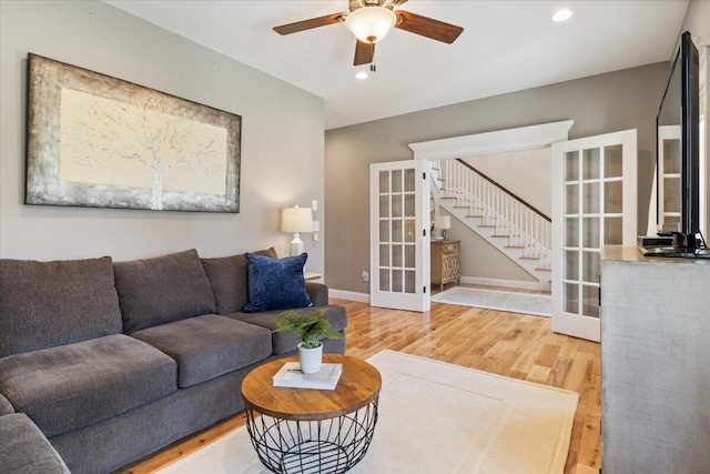 66 Grant Rd, Saco, ME 04072 - living area featuring ceiling fan, french doors, wood finished floors, stairway, and baseboards