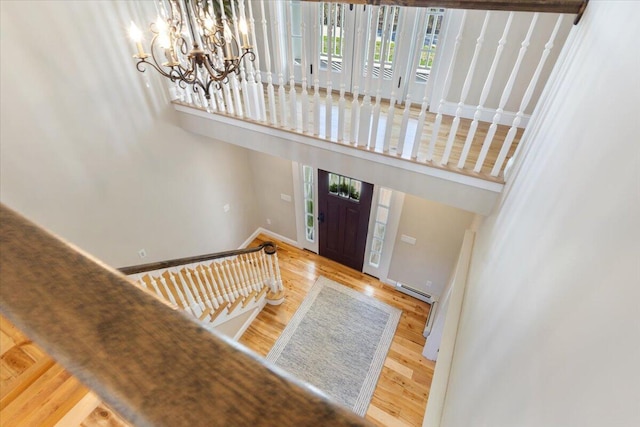 66 Grant Rd, Saco, ME 04072 - foyer with a towering ceiling, an inviting chandelier, baseboards, wood finished floors, and a baseboard radiator