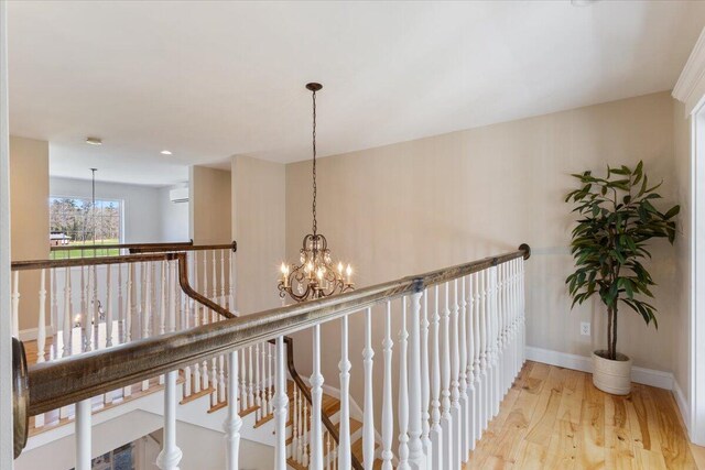 66 Grant Rd, Saco, ME 04072 - corridor with baseboards, wood finished floors, a notable chandelier, and an upstairs landing