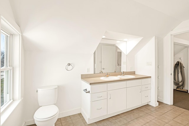 full bath featuring baseboards, tile patterned flooring, vanity, and lofted ceiling
