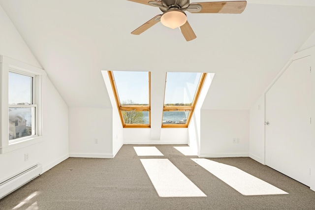 bonus room featuring carpet, a ceiling fan, baseboards, a baseboard radiator, and vaulted ceiling