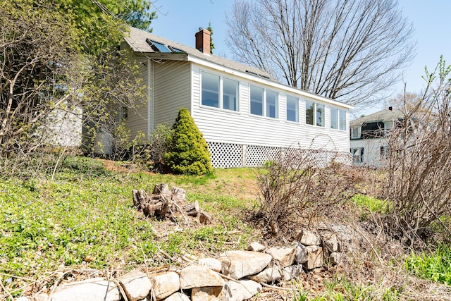 view of side of home featuring a chimney
