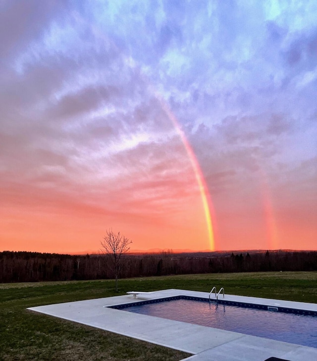 219 Middle Rd, Skowhegan, ME 04976 - pool at dusk with a diving board and a lawn