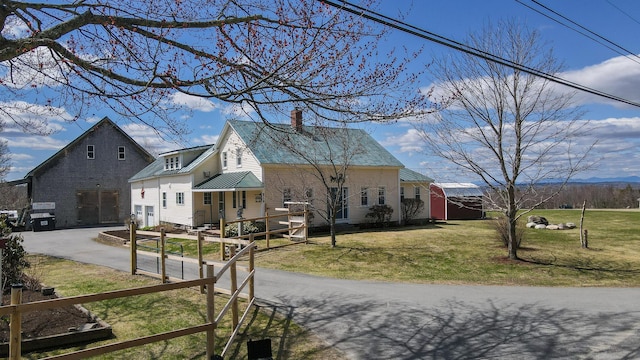 219 Middle Rd, Skowhegan, ME 04976 - view of side of property with concrete driveway, a lawn, and a chimney