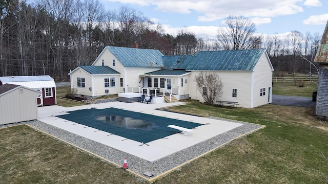 219 Middle Rd, Skowhegan, ME 04976 - back of house with a yard, a jacuzzi, a covered pool, a patio area, and metal roof