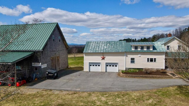 219 Middle Rd, Skowhegan, ME 04976 - view of side of home with asphalt driveway, metal roof, a garage, and a standing seam roof