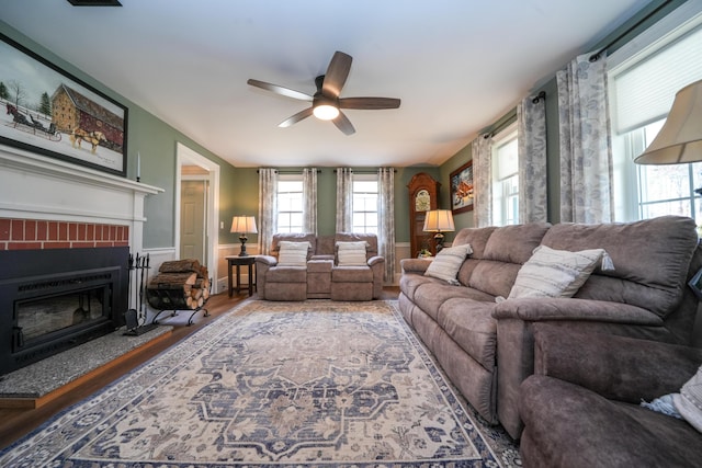 219 Middle Rd, Skowhegan, ME 04976 - living room with a ceiling fan, a brick fireplace, and wood finished floors