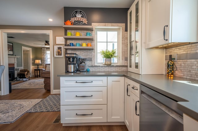 219 Middle Rd, Skowhegan, ME 04976 - kitchen featuring stainless steel dishwasher, a fireplace, dark wood-type flooring, white cabinetry, and recessed lighting