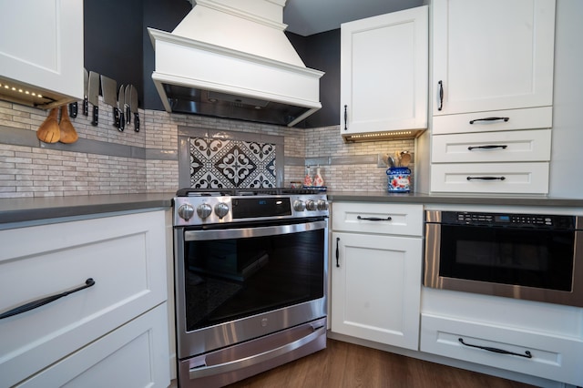 219 Middle Rd, Skowhegan, ME 04976 - kitchen with stainless steel stove, custom exhaust hood, dark countertops, and decorative backsplash