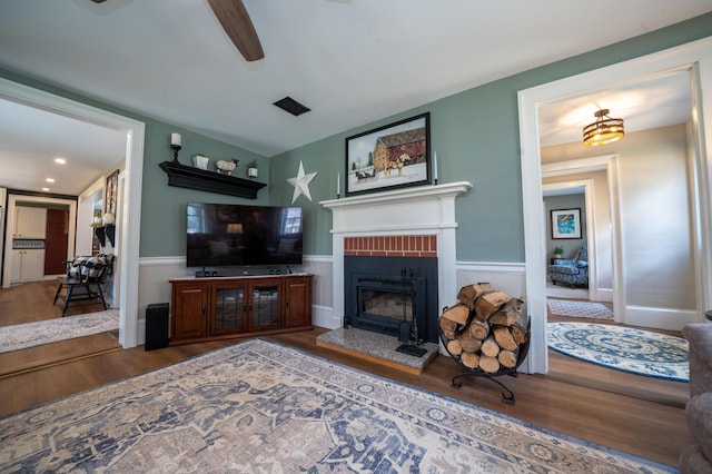 219 Middle Rd, Skowhegan, ME 04976 - living area with wood finished floors, a ceiling fan, and a fireplace