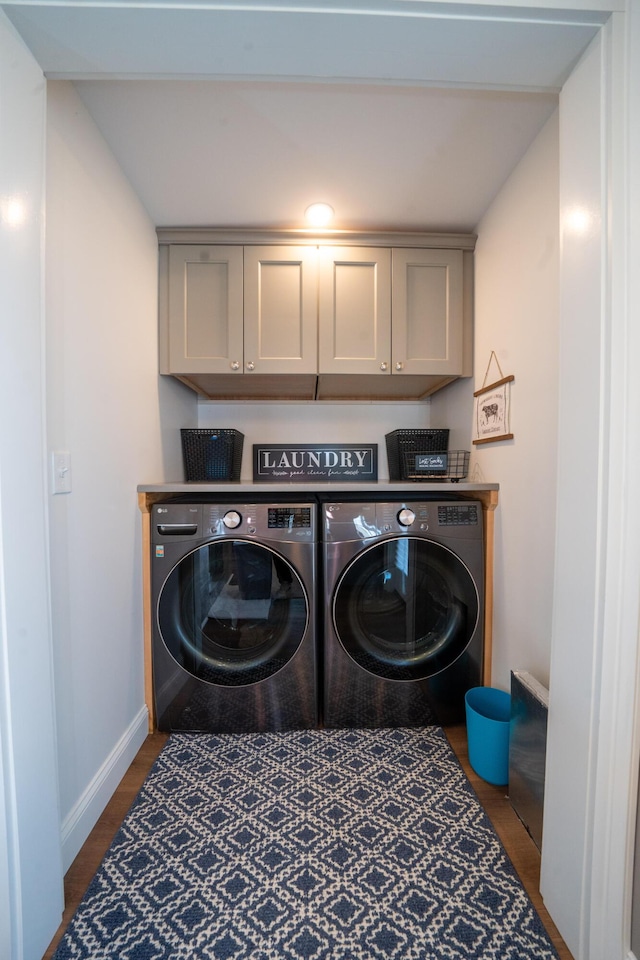 219 Middle Rd, Skowhegan, ME 04976 - laundry area with cabinet space, washing machine and clothes dryer, baseboards, and wood finished floors