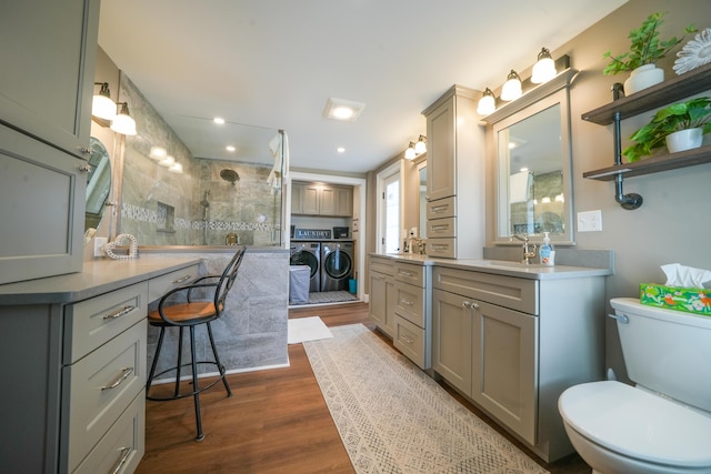 219 Middle Rd, Skowhegan, ME 04976 - full bath with washing machine and clothes dryer, a walk in shower, vanity, and wood finished floors