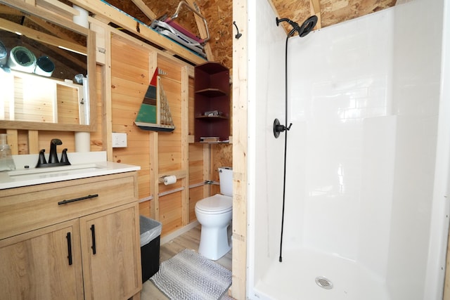 219 Middle Rd, Skowhegan, ME 04976 - full bath with vanity, a stall shower, toilet, wooden walls, and wood finished floors