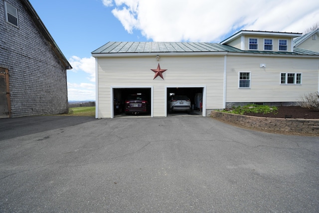 219 Middle Rd, Skowhegan, ME 04976 - view of side of home featuring a standing seam roof, a garage, and metal roof