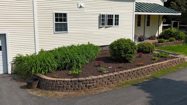 219 Middle Rd, Skowhegan, ME 04976 - view of exterior entry featuring a standing seam roof, a garage, and metal roof
