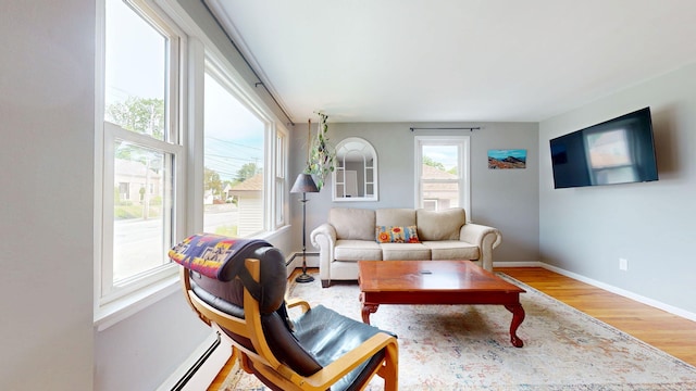 134 Saco St, Westbrook, ME 04092 - living area with wood finished floors, a baseboard radiator, and baseboards