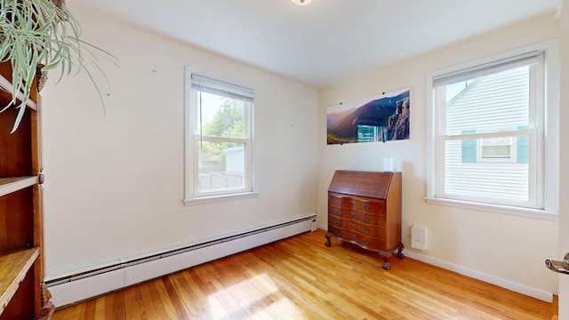 134 Saco St, Westbrook, ME 04092 - sitting room with a baseboard heating unit, light wood-type flooring, and baseboards