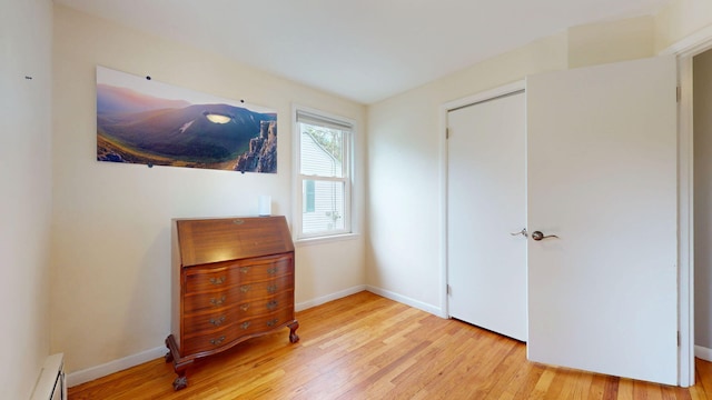 134 Saco St, Westbrook, ME 04092 - bedroom with a baseboard heating unit, wood finished floors, and baseboards