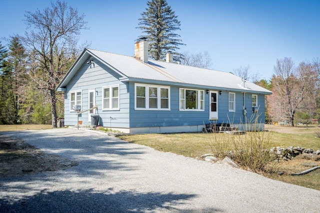 ranch-style house with a chimney and metal roof