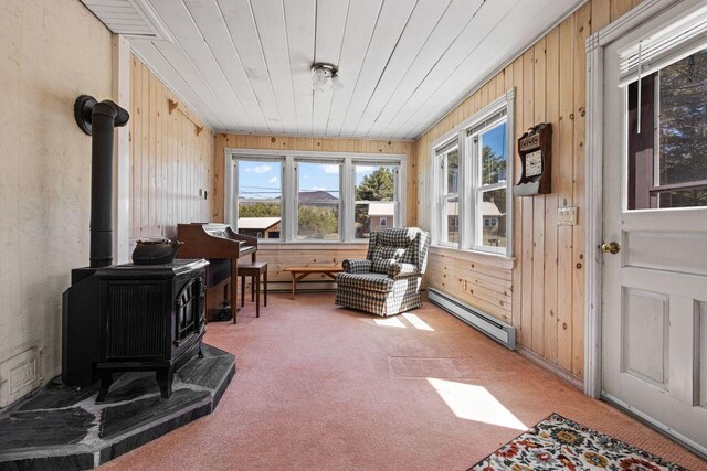 sunroom / solarium with a wood stove and baseboard heating