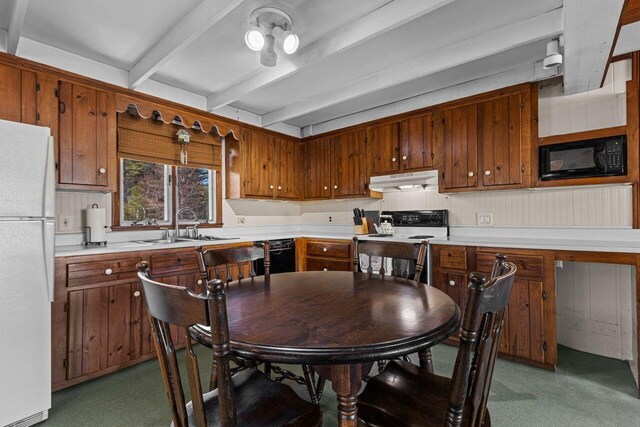 kitchen featuring range with electric cooktop, a sink, freestanding refrigerator, beamed ceiling, and light countertops