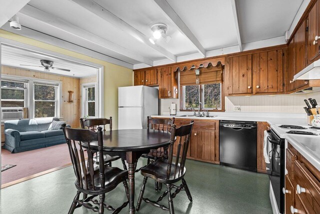 kitchen with a sink, a wealth of natural light, freestanding refrigerator, black dishwasher, and range with electric stovetop