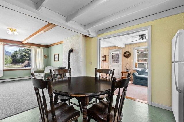 dining area with baseboard heating, baseboards, beam ceiling, and ceiling fan