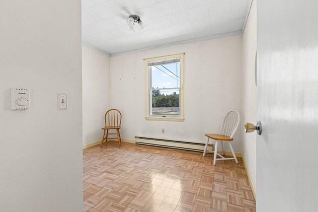 unfurnished room featuring baseboard heating, baseboards, and crown molding