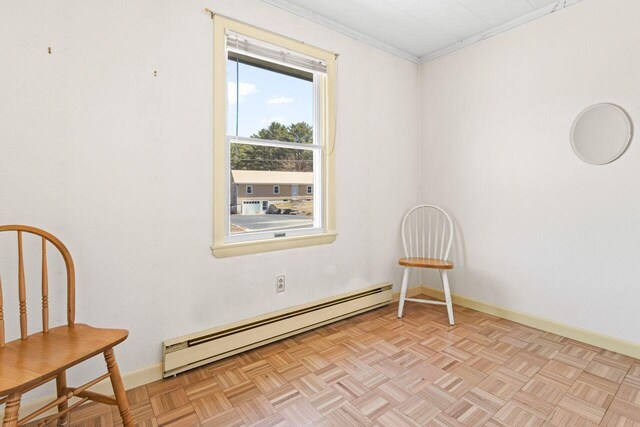 unfurnished room with a baseboard radiator, baseboards, and ornamental molding