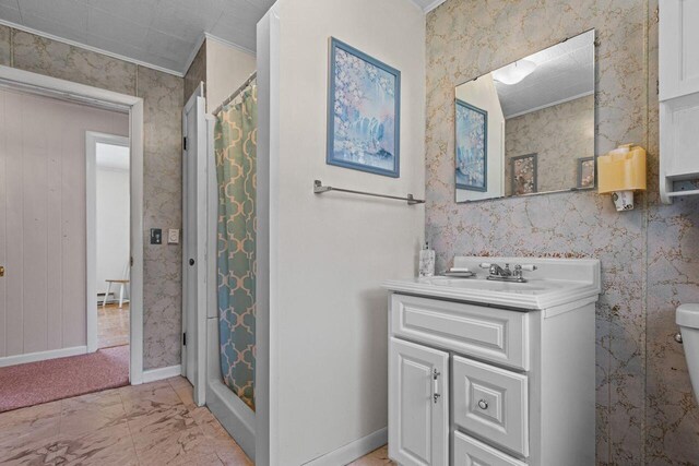 bathroom with a shower stall, marble finish floor, toilet, vanity, and ornamental molding