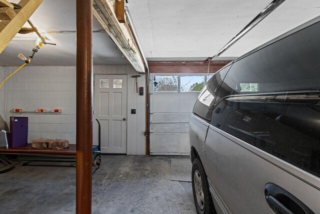 garage featuring concrete block wall