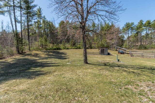 view of yard with fence and a view of trees