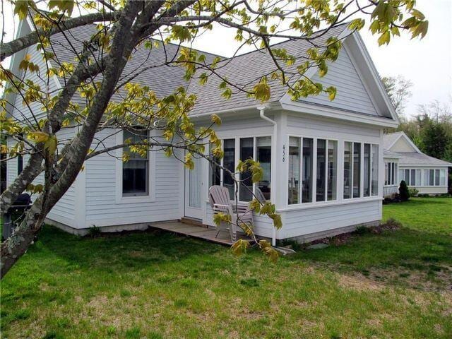 454 Post Rd Unit 456, Wells, ME 04090 - back of property featuring roof with shingles, a yard, and a sunroom