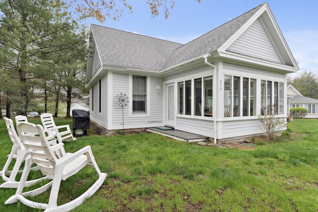 454 Post Rd Unit 456, Wells, ME 04090 - rear view of house featuring a shingled roof, a sunroom, and a lawn