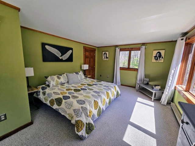 bedroom with carpet floors, baseboards, and crown molding