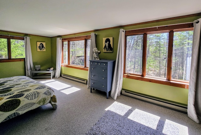 carpeted bedroom featuring a baseboard radiator and multiple windows