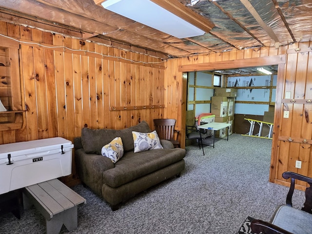 carpeted living area featuring wooden walls