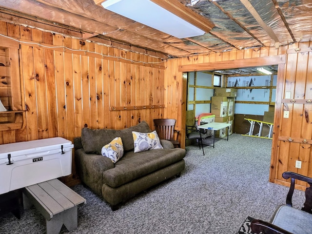 living area featuring carpet floors and wood walls