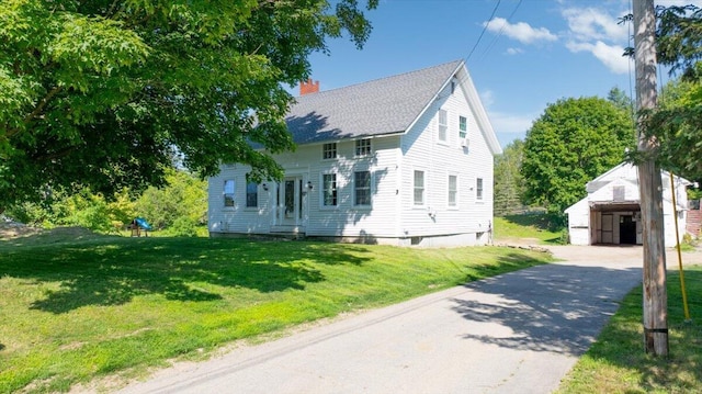 817 Riverside Dr, Augusta, ME 04330 - view of front of property featuring an outdoor structure, a chimney, a front lawn, and a shingled roof