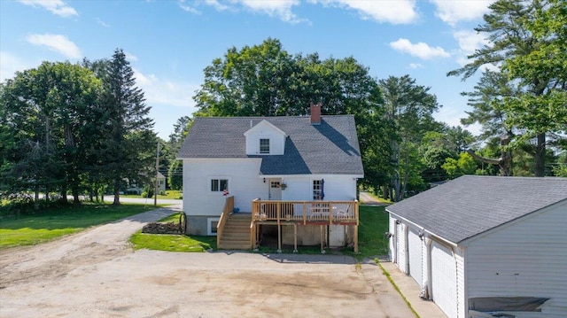 817 Riverside Dr, Augusta, ME 04330 - back of house featuring a deck, a chimney, a garage, stairway, and view of wooded area