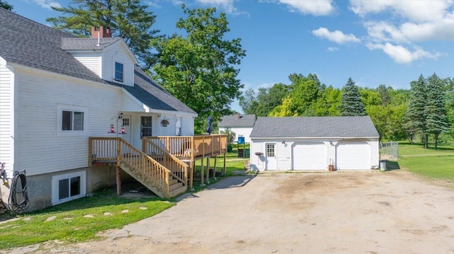 817 Riverside Dr, Augusta, ME 04330 - view of home's exterior with an outdoor structure, a garage, and a lawn